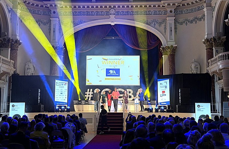 Six people on stage at Town hall with yellow and blue strobe lights