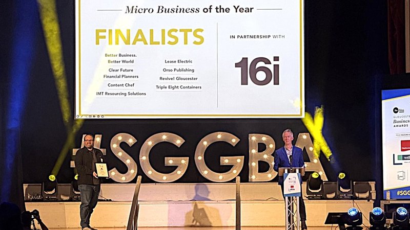 two men on stage with Finalists sign in the background