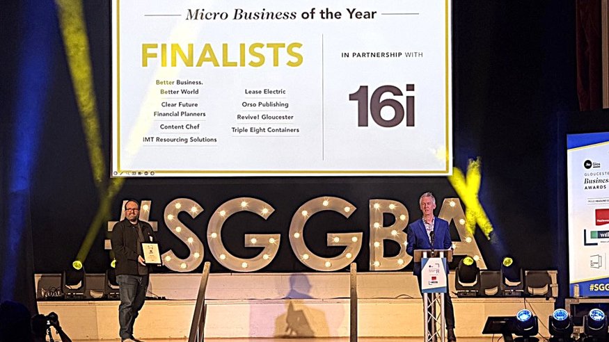 two men on stage with Finalists sign in the background